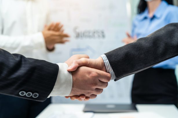 Asian businessman and woman handshake after negotiations for Business deal.