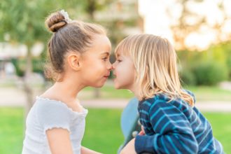 Children pressed their noses to each other