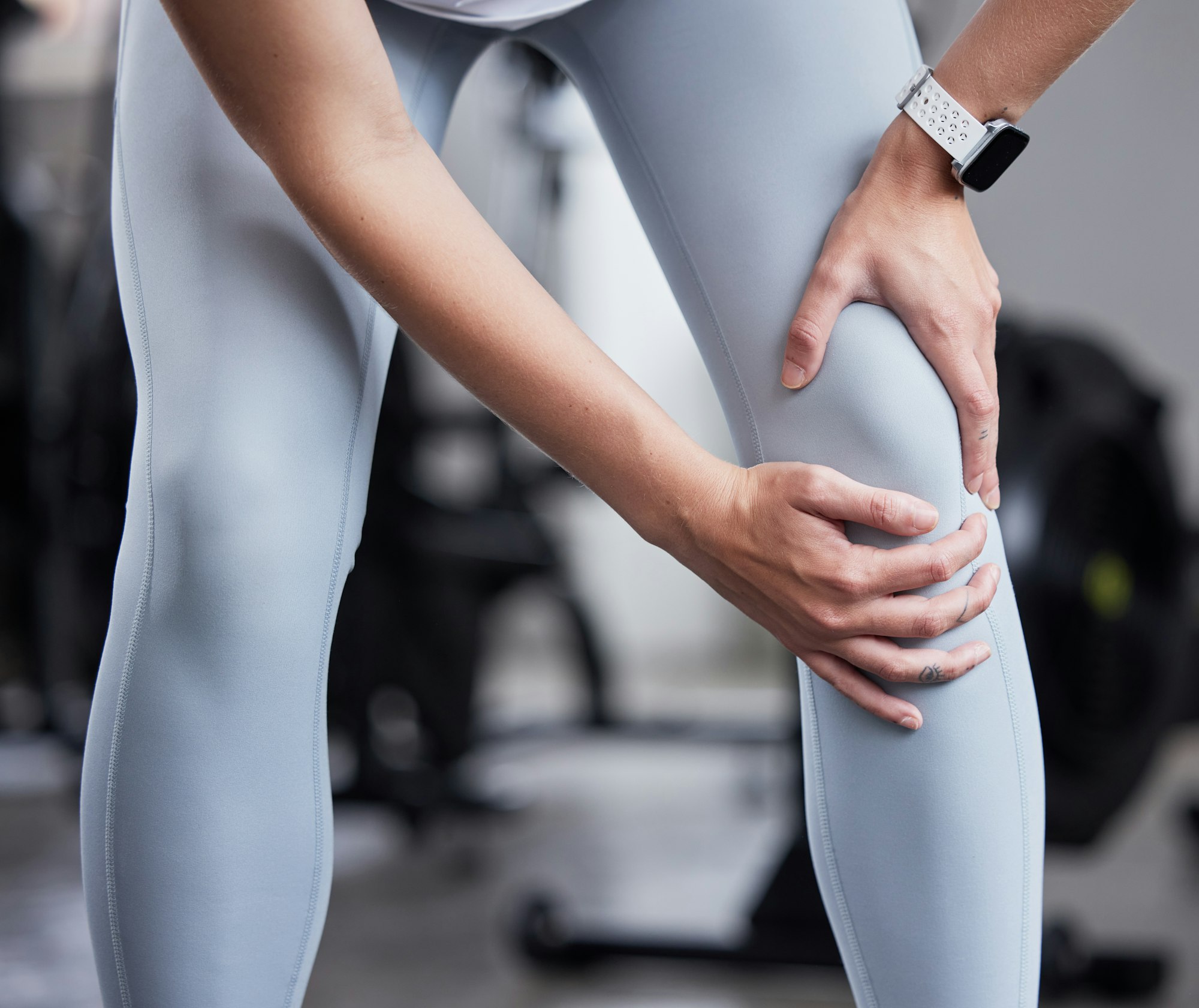 Hand, leg pain and woman at the gym in fitness fail, muscle training mistake or joint discomfort. S