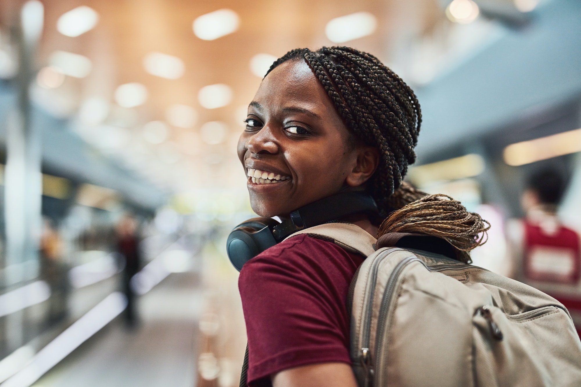 Im flying solo. Cropped shot of a happy young woman at the airport.