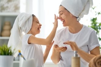 Mother and daughter caring for skin