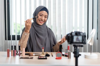 Woman muslim blogger is showing present make up tutorial beauty cosmetic review product